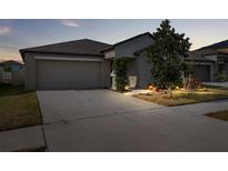 Well-maintained house with a landscaped lawn, driveway and garage at 6807 King Creek Dr, Sun City Center, FL 33573