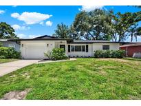 Charming single-story home with a well-manicured lawn and beautiful landscaping at 980 5Th Ne Ave, Largo, FL 33770