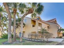 Attractive multi-story home with a blue front door, palm trees, and a two-car garage at 1630 Royal Palm S Dr # A, St Petersburg, FL 33707