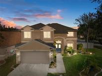 Two-story house with a large yard, double garage, and walkway at 19301 Sandy Springs Cir, Lutz, FL 33558