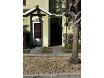 Front exterior of a two-story home with a brown door and green siding at 6023 Osprey Lake Cir, Riverview, FL 33578