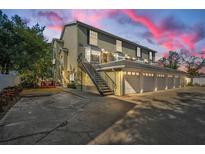 Three-story building with attached garages and outdoor parking at 609 S Glen Ave # B, Tampa, FL 33609