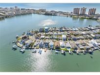 Aerial view of waterfront homes with private docks and boats at 943 182Nd E Ave, Redington Shores, FL 33708
