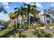 Exterior view of condo building with lush landscaping and palm trees at 10265 Gandy N Blvd # 905, St Petersburg, FL 33702