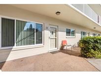 Exterior view of condo building, showing entrance with chair and landscaping at 2262 Swedish Dr # 12, Clearwater, FL 33763