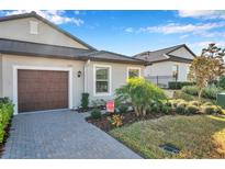 Single-story home with a two-car garage and well-manicured landscaping at 31371 Cabana Rye Ave, San Antonio, FL 33576