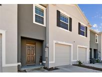 Modern two-story townhome with attached garage and neutral color palette at 1579 Hubbell Rd, Wesley Chapel, FL 33543