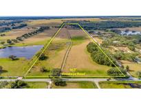 Aerial view of expansive property with road frontage and surrounding pastureland at 9229 Fort King Rd Rd, Dade City, FL 33525