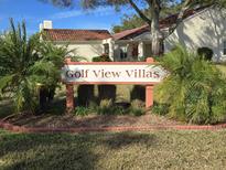 Golf View Villas community entrance sign with lush landscaping at 947 Madrid Dr, Palm Harbor, FL 34684