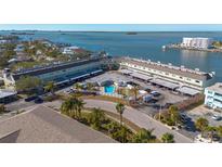 Aerial view of a waterfront condo community with a pool at 433 S Paula Dr # 32, Dunedin, FL 34698