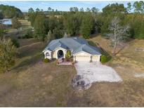 Aerial view of a single-story house with a large yard and barn at 4347 Eva Lou Dr, Brooksville, FL 34602