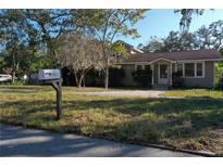 Cute one-story house with a well-maintained lawn at 1149 Sedeeva St, Clearwater, FL 33755