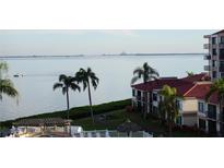 View of the water with palm trees, buildings, and a boat at 6218 Palma Del Mar S Blvd # 503, St Petersburg, FL 33715