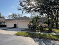 Beautiful single-story home with a well-manicured lawn and mature landscaping at 6325 Stone River Rd, Bradenton, FL 34203