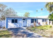 Light blue house with a white fence and palm trees at 4234 Harrisburg Ne St, St Petersburg, FL 33703