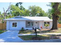 Charming one-story brick home with a new metal roof and nicely landscaped front yard at 1012 Sagamore Dr, Seffner, FL 33584