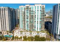 Aerial view of a modern high-rise condominium building with balconies and city views at 450 Knights Run Ave # 1102, Tampa, FL 33602
