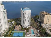 Aerial view of waterfront high rise building with tennis court and pool at 3435 Bayshore Blvd # 601S, Tampa, FL 33629