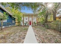 Charming home with a red door, wooden accents, and a welcoming front yard at 807 E Genesee St # 1/2, Tampa, FL 33603