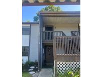 Exterior view of condo building with private entrance and balcony at 11616 Baywood Meadows Dr # 7, New Port Richey, FL 34654
