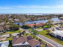 Aerial view of waterfront home with canal access and lush landscaping at 1998 Massachusetts Ne Ave, St Petersburg, FL 33703