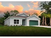 Newly constructed one-story home with a green garage door and well-manicured lawn at 20118 Quesada Ave, Port Charlotte, FL 33952