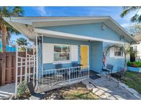 Home's exterior showcasing a yellow door and a porch at 3007 56Th S St, Gulfport, FL 33707