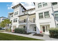 White two-story townhome with balcony and landscaping at 5351 Bridge St # 22, Tampa, FL 33611