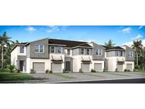 Modern 3-unit townhome building with attached garages and landscaping at 5655 Brooklet Woods Dr, Wesley Chapel, FL 33545