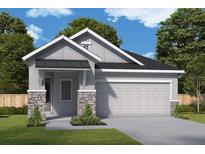 Charming single-story home with a two-car garage, stone accents and manicured lawn at 633 Allora Ave, Nokomis, FL 34275