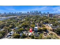 Stunning aerial view of the city skyline, tree-lined neighborhood and home's location at 408 E Amelia Ave, Tampa, FL 33602