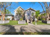 Charming single-story home featuring a quaint front porch, inviting entrance, and well-maintained landscaping at 408 E Amelia Ave, Tampa, FL 33602