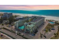 Stunning aerial view of a beachfront condo complex with turquoise waters and white sandy beaches at 12000 Gulf Blvd # 208-S, Treasure Island, FL 33706