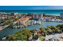 Aerial view of waterfront property, showing a house and marina at 249 Boca Ciega Dr, Madeira Beach, FL 33708