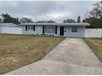 Newly renovated 1950s home with gray exterior, new landscaping, and a long driveway at 5700 38Th N Ave, St Petersburg, FL 33710