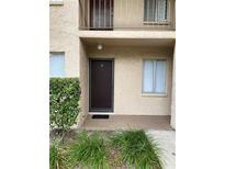 Exterior view of condo building showing entrance and landscaping at 7519 Pitch Pine Cir # 171, Tampa, FL 33617