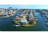 An aerial view of the house shows its location on a canal with water access and boat dock at 224 7Th E St, Tierra Verde, FL 33715
