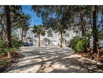 Gray townhouses with private driveways and lush landscaping at 514 Ryans Woods Ln, Palm Harbor, FL 34683