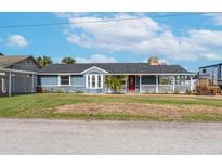 Charming single-story home with a spacious front yard and updated facade at 8510 Magnolia St, Gibsonton, FL 33534