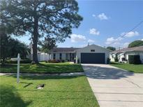 Charming single-story home with a well-maintained lawn and attached garage at 6018 Bayou Grande Ne Blvd, St Petersburg, FL 33703