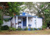 Charming bungalow with a covered porch and well-maintained landscaping at 21 Highland Ave, Dunedin, FL 34698