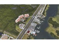 Aerial view of waterfront condo community with pool and boat slips at 12055 Gandy N Blvd # 231, St Petersburg, FL 33702