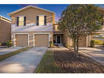 Two-story townhome with two-car garage and landscaped yard at 4312 Silver Falls Dr, Land O Lakes, FL 34639