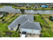 Aerial view of single-Gathering home with two-car garage and waterfront lot at 5440 Sandy Shell Dr, Apollo Beach, FL 33572