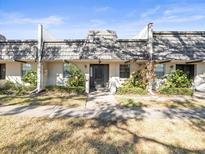 Front view of condo building, showing landscaping and building exterior at 8755 Bardmoor Blvd # 105, Seminole, FL 33777