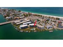 Aerial view of waterfront property with community pool and boat slips at 9815 Harrell Ave # 302, Treasure Island, FL 33706