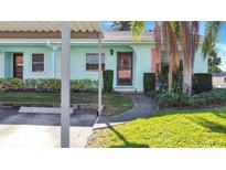 Light blue home with a covered carport and landscaped yard at 2465 Northside Dr # 1808, Clearwater, FL 33761