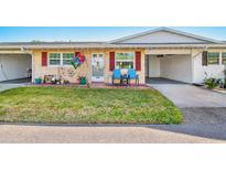 Inviting exterior of a single story home with landscaped lawn and carport at 5005 Lily Street N Pl, Pinellas Park, FL 33782