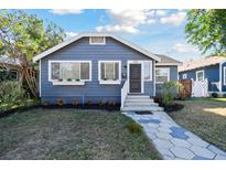 Charming bungalow with gray siding, landscaped lawn, and a stone walkway at 2230 6Th N Ave, St Petersburg, FL 33713