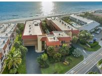 Aerial view of beachfront condo complex with pool and ocean views at 6006 Gulf Dr # 207, Holmes Beach, FL 34217
